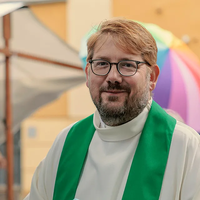 Pfarrer Björn Borrmann in weißer Albe mit grüner Stola